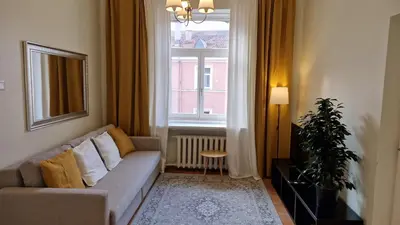 a living room with a couch and a window at TyzenXL Luxury Vilnius Apartments in Vilnius