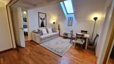 a living room with a white couch and a table at TyzenXL Luxury Vilnius Apartments in Vilnius