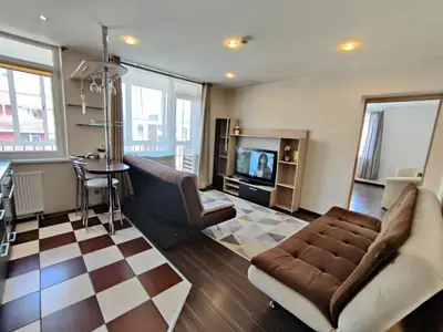 a living room with a couch and a television at Apartments near BIG in Vilnius