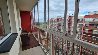 an apartment balcony with a view of a building at Apartments near BIG in Vilnius