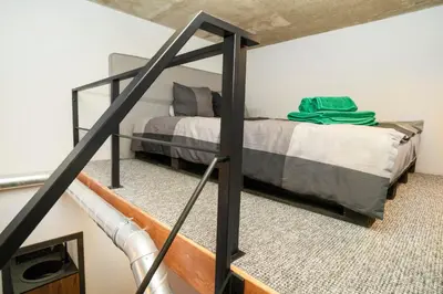 a bedroom with a bed in a loft at Teeny Tiny Lofts in Center in Kaunas