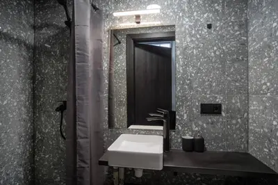 a bathroom with a sink and a mirror at Teeny Tiny Lofts in Center in Kaunas