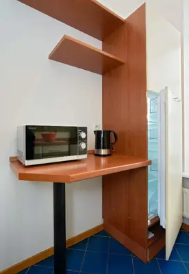 a microwave on a wooden counter in a kitchen at ReHouse- Didzioji 39 in Vilnius