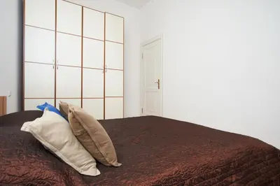 a bedroom with a bed with pillows on it at ReHouse- Didzioji 39 in Vilnius