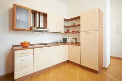 a kitchen with white cabinets and a sink and a microwave at ReHouse- Didzioji 39 in Vilnius