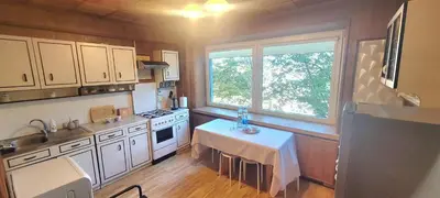 a kitchen with a table in the middle of it at Hostel 4 in Šiauliai