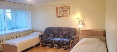 a room with a bed and a chair and a window at Hostel 4 in Šiauliai