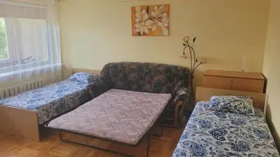 a small room with a couch and a bed at Hostel 4 in Šiauliai