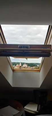 a window in the ceiling of a room at Apartments in the old town with an impressive view in Vilnius