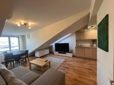 a living room with a couch and a table at Apartments in the old town with an impressive view in Vilnius