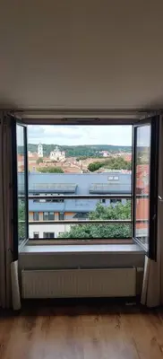a large window with a view of a building at Apartments in the old town with an impressive view in Vilnius