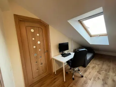 a room with a desk with a computer and a window at Apartments in the old town with an impressive view in Vilnius
