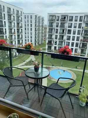 a balcony with a table and chairs and a courtyard at B23 Apartments in Vilnius