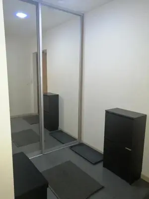a room with a large mirror and a television at B23 Apartments in Vilnius
