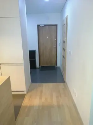 an empty room with a door and a wooden floor at B23 Apartments in Vilnius