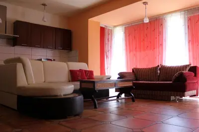 a living room with two couches and a table at Jauku Erdvu Šilta in Kaunas
