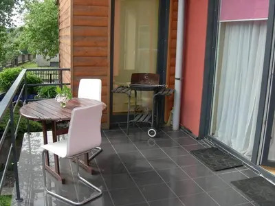 a patio with a table and chairs and a grill at Jauku Erdvu Šilta in Kaunas