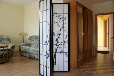 a glass door in a living room with a couch at Jauku Erdvu Šilta in Kaunas