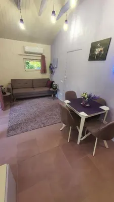 a living room with a couch and a table at Violetinis namelis/ Sodyba Geras in Anykščiai