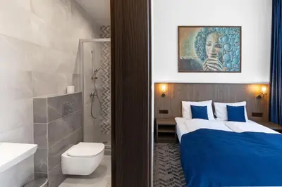 a bathroom with a bed and a toilet and a sink at AN Hotel self check-in in Šiauliai