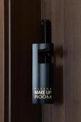 a black door knob with the words please make up room at AN Hotel self check-in in Šiauliai