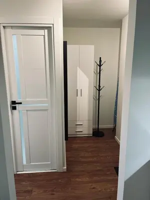 an empty room with a door and a cross at Sun Clock Apartment in Šiauliai