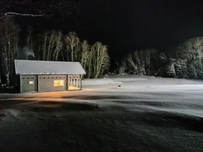 a small cabin in a field at night at Sodyba vienkiemyje 