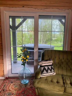 a living room with a couch and a vase of flowers at Sodyba vienkiemyje 