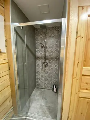 a shower with a glass door in a bathroom at Sodyba vienkiemyje 