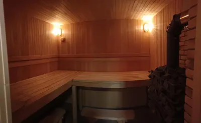 a sauna with a wooden bench and lights in it at Sodyba vienkiemyje 