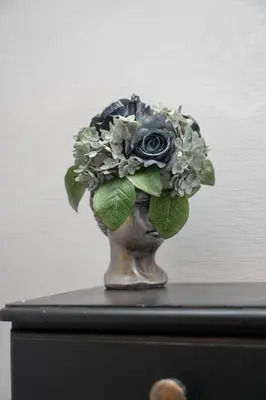 a vase with a bouquet of flowers on a table at Church through the window in Vilnius