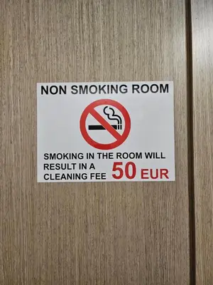 a sign on a door that says no smoking room at Kauno apartamentai big bed in Kaunas