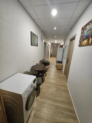 a hallway of a hospital with a washing machine at Kauno apartamentai big bed in Kaunas