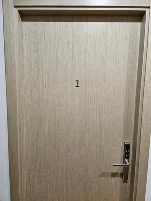 a wooden door with a handle in a room at Kauno apartamentai big bed in Kaunas