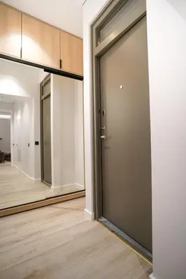 an empty room with a door and a mirror at Old Town apartment in Kaunas