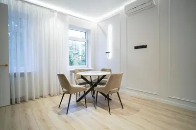 a dining room with a table and chairs and a window at Old Town apartment in Kaunas