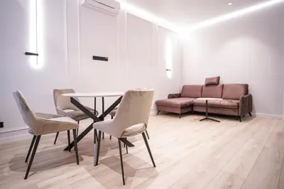 a living room with a table and chairs and a couch at Old Town apartment in Kaunas