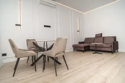 a dining room with a table and chairs and a couch at Old Town apartment in Kaunas