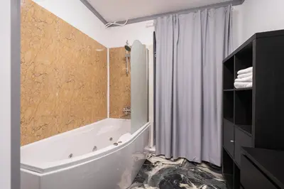 a bathroom with a tub and a toilet and a shower at Klaipedos Apartment - Lollo Stay in Vilnius