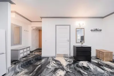 a living room with a marble floor and a door at Klaipedos Apartment - Lollo Stay in Vilnius