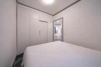 a white bedroom with a white bed in it at Klaipedos Apartment - Lollo Stay in Vilnius