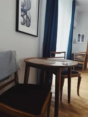 a table and a chair in a room at City Center Apartments in Vilnius