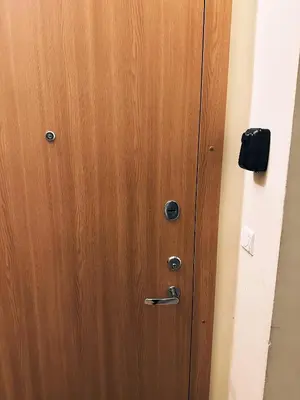 a wooden door with metal knobs on it at City Center Apartments in Vilnius