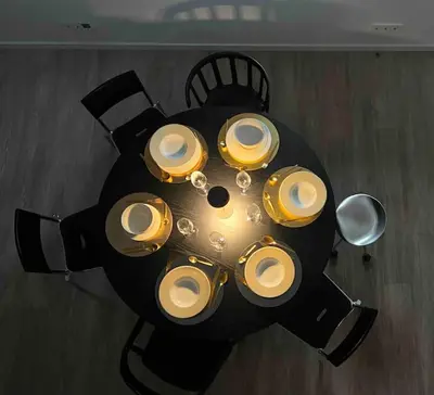 a black table with plates and dishes on it at KAUNAS ATTIC, Apartment in the heart of Kaunas in Kaunas