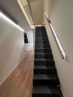 a staircase in a building with a black stair case at KAUNAS ATTIC, Apartment in the heart of Kaunas in Kaunas