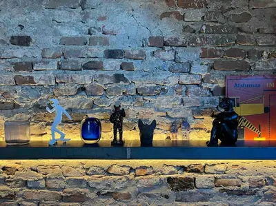 a shelf with figurines of cats and a wall at KAUNAS ATTIC, Apartment in the heart of Kaunas in Kaunas