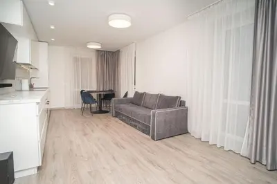 a living room with a couch and a table at Oldtown art apartaments in Kaunas