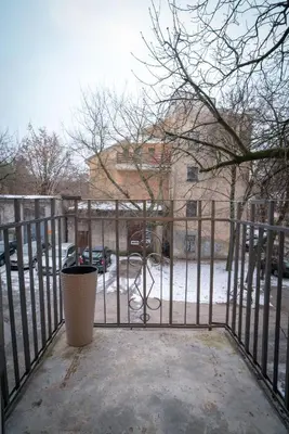 a gate to a parking lot with snow on the ground at Oldtown art apartaments in Kaunas