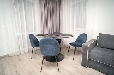 a dining room with a table and chairs and a couch at Oldtown art apartaments in Kaunas