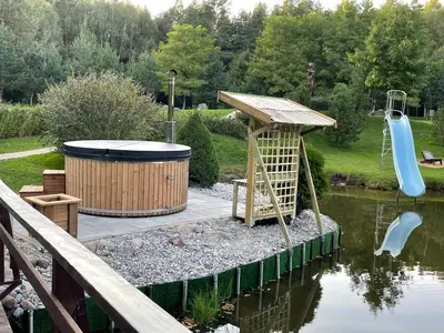 a water park with a water slide and a playground at Ramybės parkas in Sponėnai
